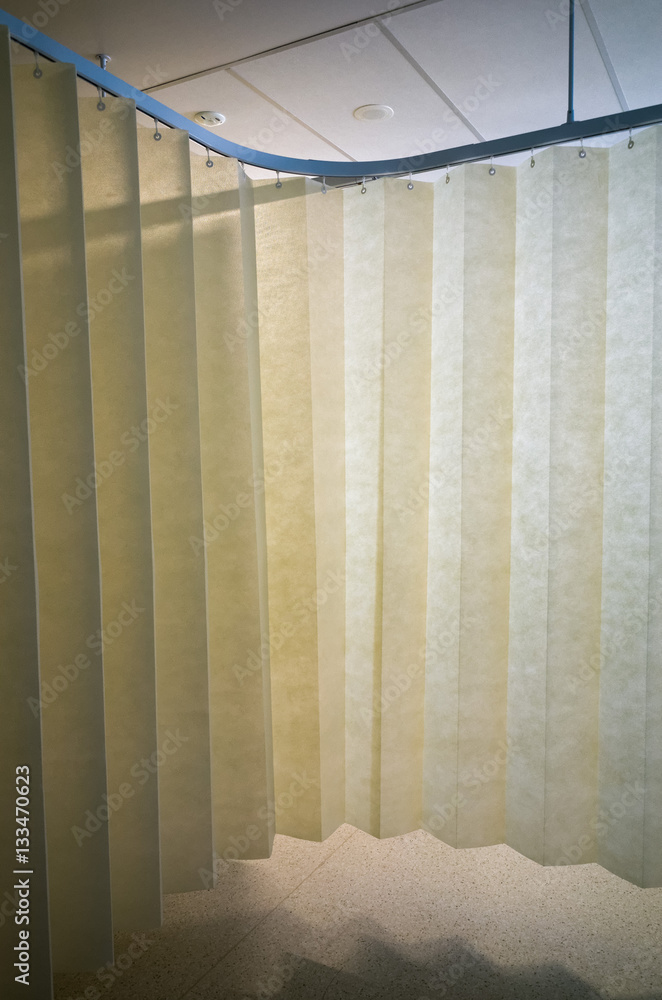 Hanging dividing curtain in a hospital ward. Folding room divider