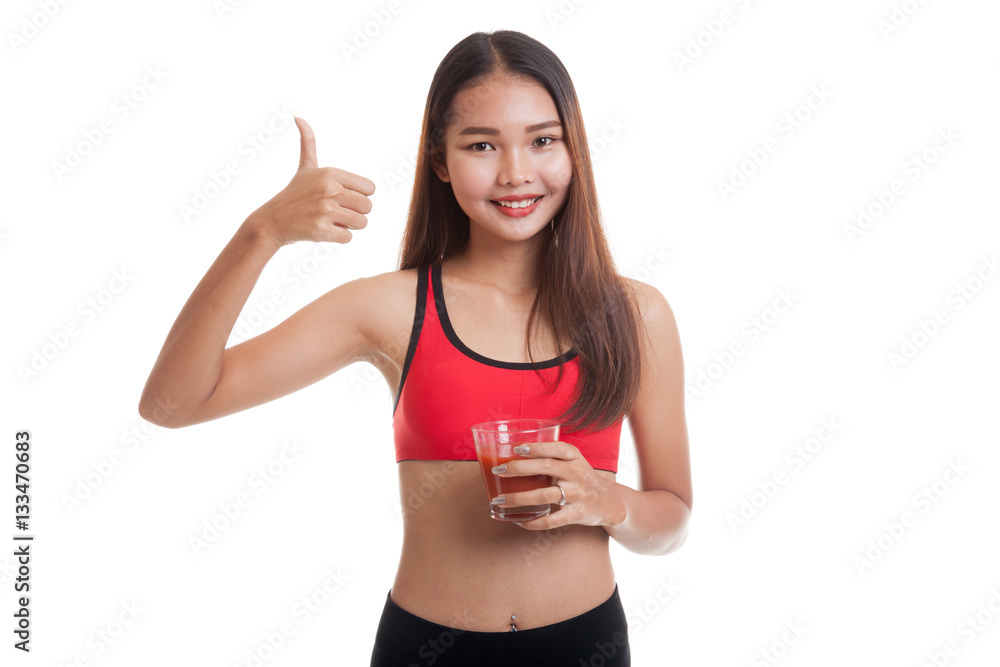 Beautiful healthy Asian girl thumbs up with tomato juice. Beautiful healthy Asian girl thumbs up with tomato juice.