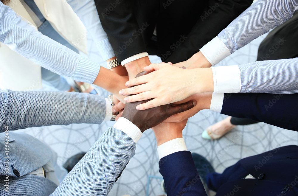 Group of business people joining hands Group of business people joining hands