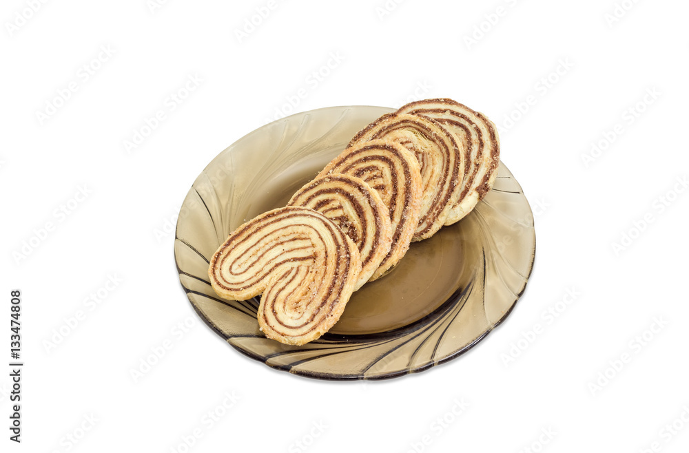 Flaky cookies with chocolate filling on glass saucer Flaky cookies with chocolate filling on glass saucer