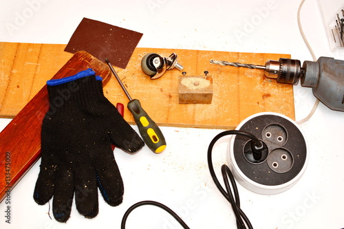 Carpentry tools - hand drill, screwdriver, extension cable, protective gloves, costor photo