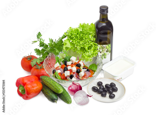 Fototapeta Naklejka Na Ścianę i Meble -  Greek salad among ingredients for its cooking on light backgroun