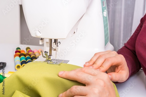 Fashion woman sews with sewing machine