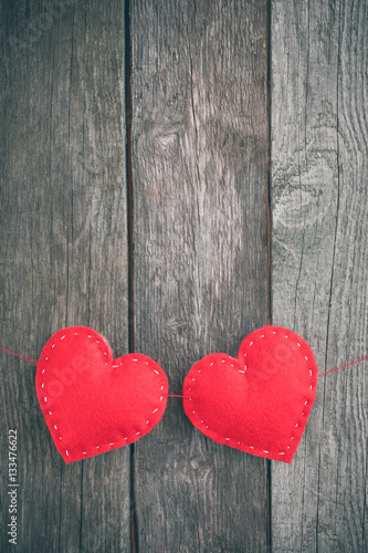 Valentine s day card. Red felt heart placed on vintage wood background and space for your text.