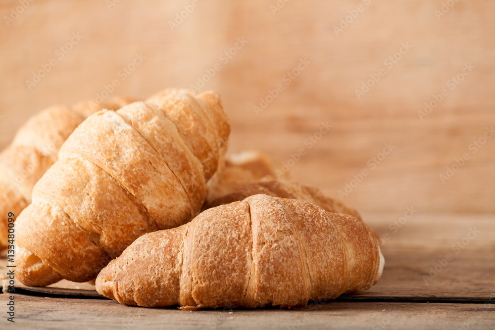 Fresh croissant on wood desk