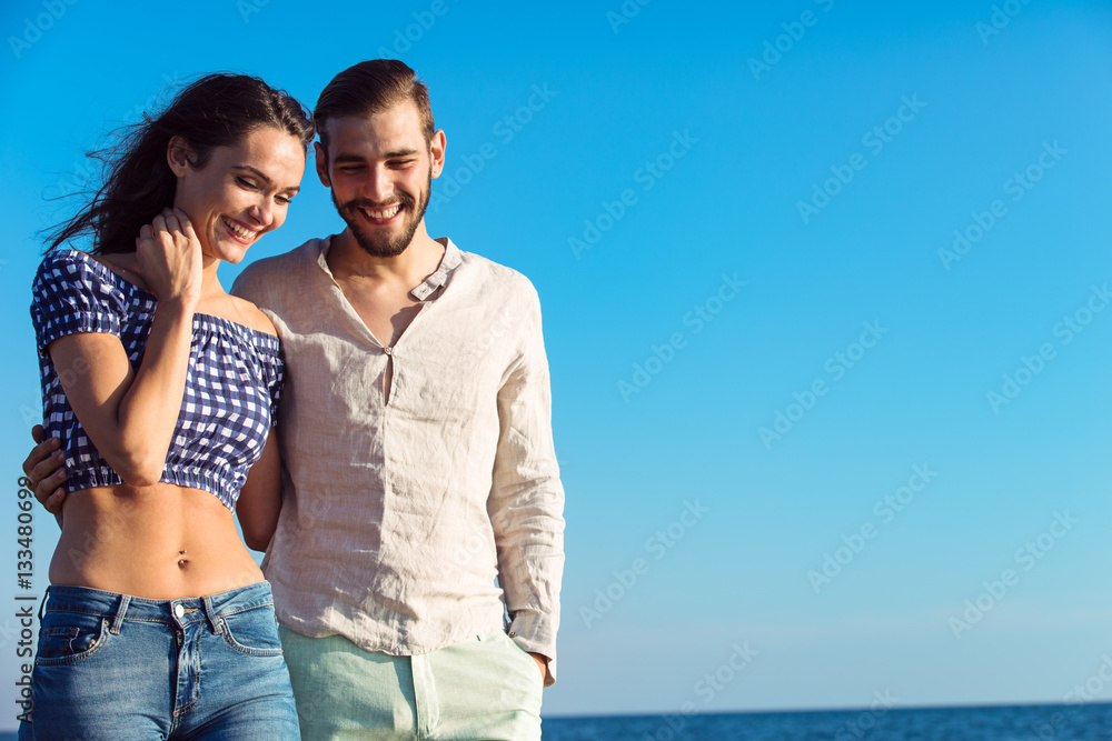 Couple walking on beach. Young happy interracial couple walking on beach. Couple walking on beach. Young happy interracial couple walking on beach.