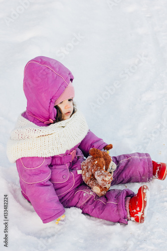 Baby girl sitting in the snow