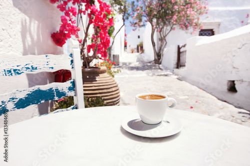 Fototapeta Naklejka Na Ścianę i Meble -  Traditional greek coffee in a cafe with beautiful mediterranean street on the background