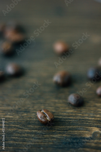 Coffee beans on black wooden board.