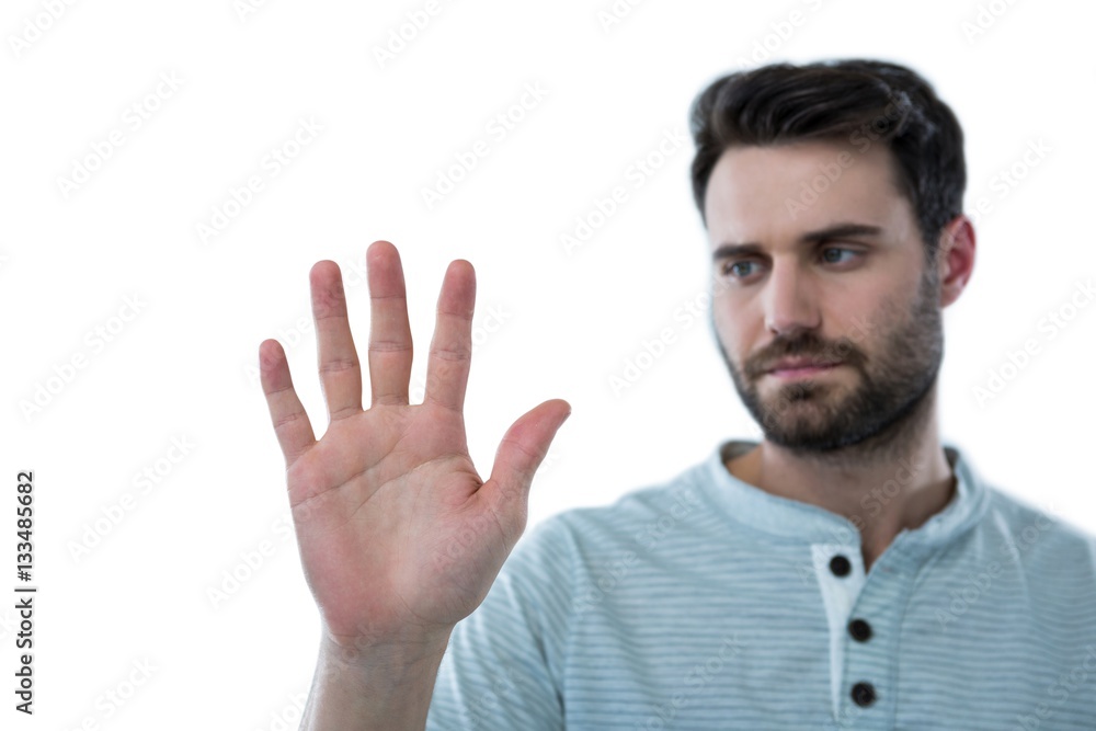 Man pretending to touch an invisible screen Man pretending to touch an invisible screen