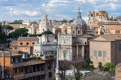 Rome city view with church cupolas in sunny day, view from the Roman Forum, Italy