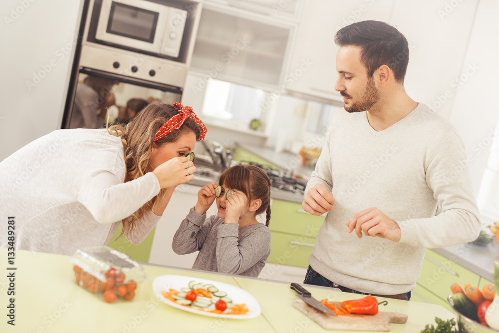 Happy family preparing food in kitchen Happy family preparing food in kitchen