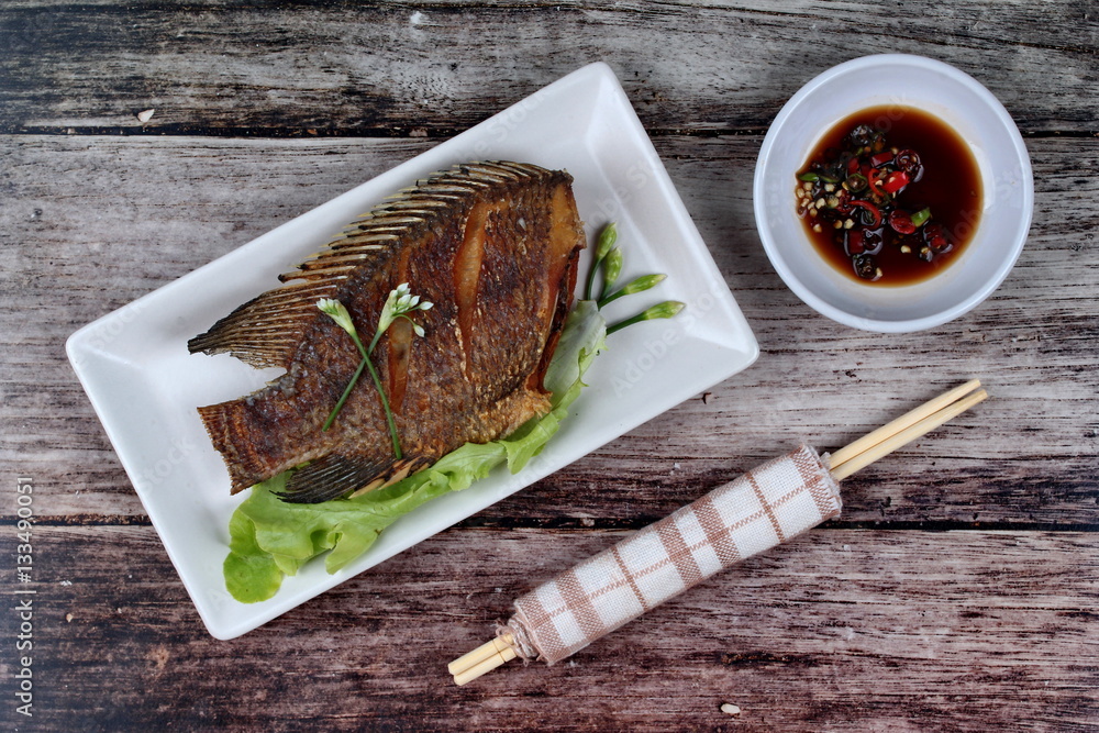 Deep fried little tilapia fish served with spicy bean sauce. StockFoto