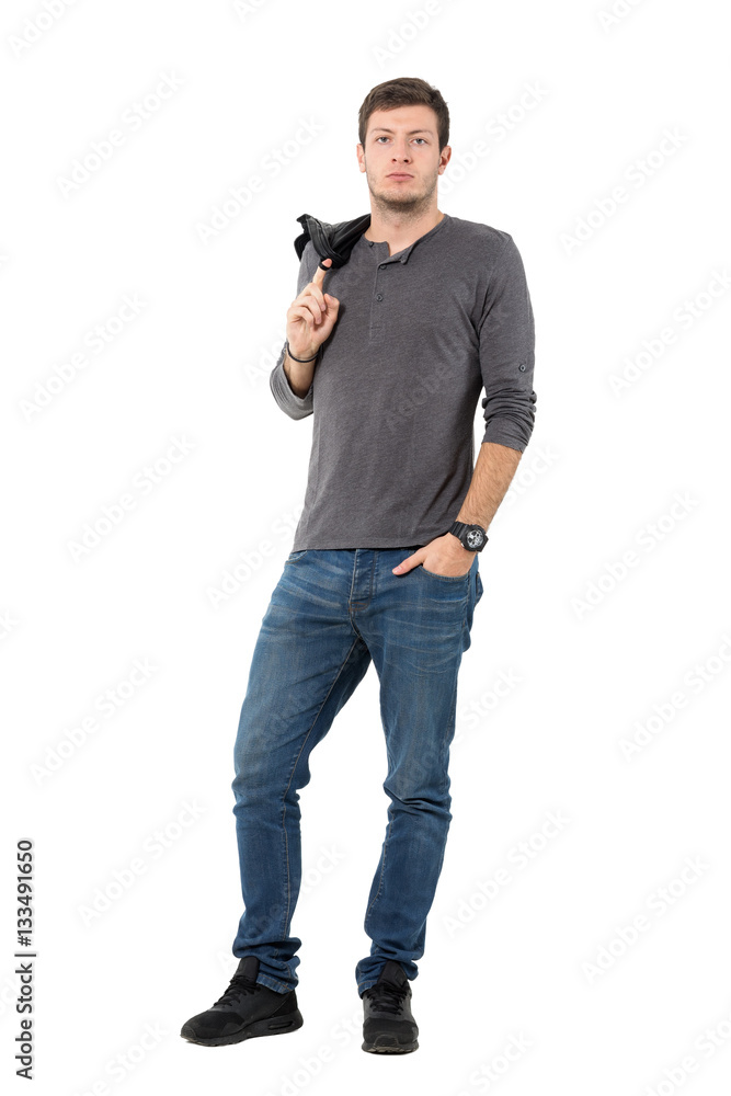 Handsome casual man carrying jacket over shoulder looking at camera. Full body length portrait isolated over white background. Handsome casual man carrying jacket over shoulder looking at camera. Full body length portrait isolated over white background.