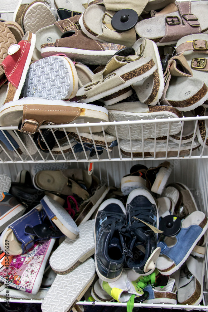 Pile of flip flops and sandals in the shop. Heap of slippers on offer cheap  store. Domestic and summer shoes at market. Stock-Foto | Adobe Stock