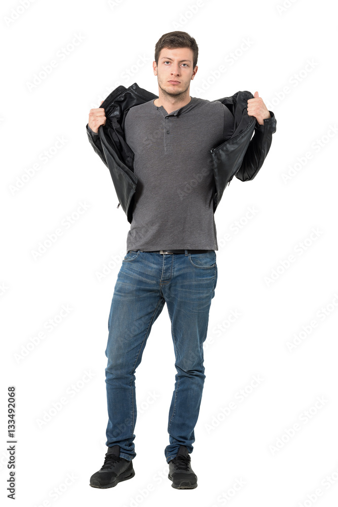 Casual man taking off jacket looking at camera. Full body length portrait isolated over white background. Casual man taking off jacket looking at camera. Full body length portrait isolated over white background.