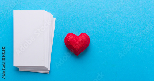 Red heart and white blank card. Love Valentine's Day. Blue background © adragan