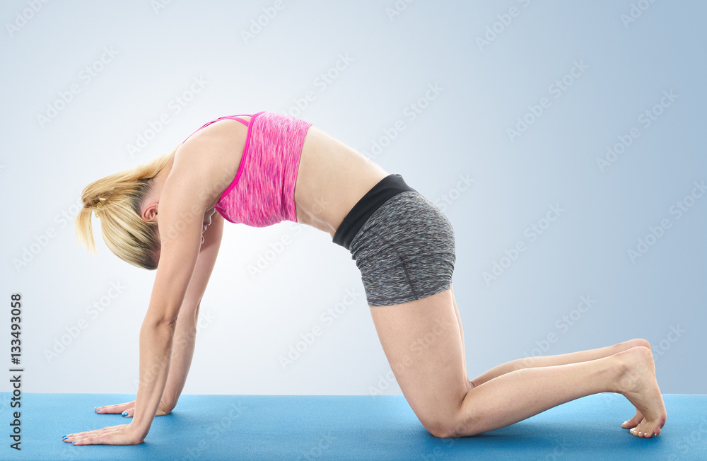 Woman making pilates mat exercises Woman making pilates mat exercises