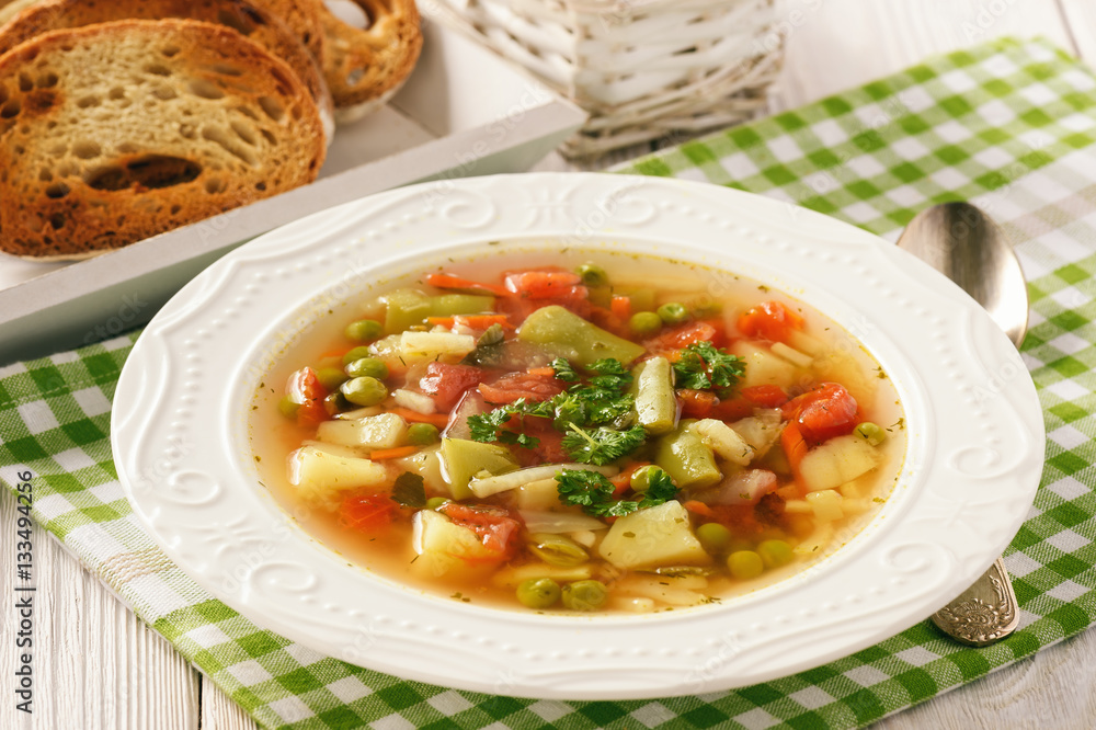 Vegetarian vegetable soup on wooden background. Vegetarian vegetable soup on wooden background.