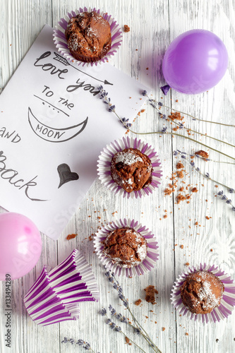 concept of Valentine's Day cupcakes wooden background top view