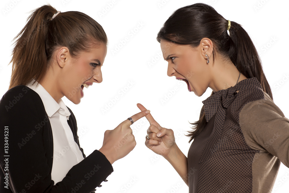 Two young angry woman yelling at each other Two young angry woman yelling at each other