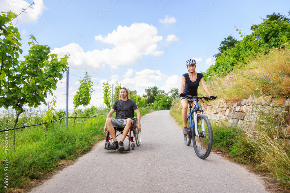 Young Couple In Wheelchair Enjoying Time Outdoors