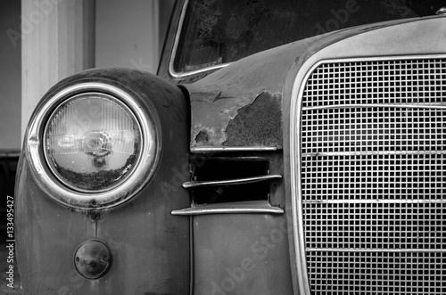 The front side of an old car. Giving emphasis to metal parts.No matter its age,luxury and magnificence still dominate.