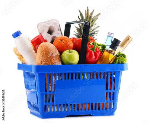 Plastic shopping basket with assorted grocery products
