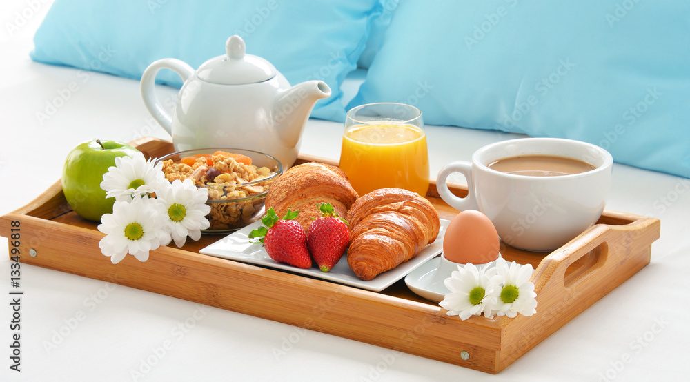Breakfast tray in bed in hotel room Breakfast tray in bed in hotel room