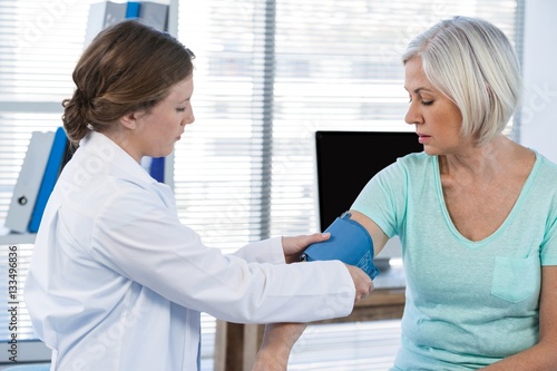 Female doctor checking blood pressure of a patient © WavebreakMediaMicro
