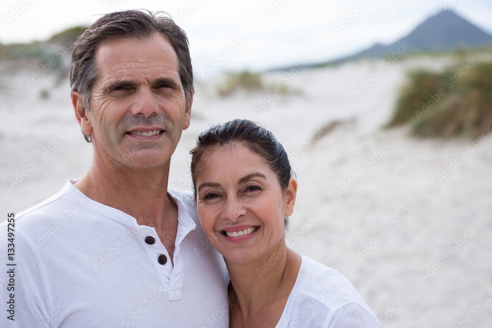 Portrait of happy couple standing on beach Portrait of happy couple standing on beach