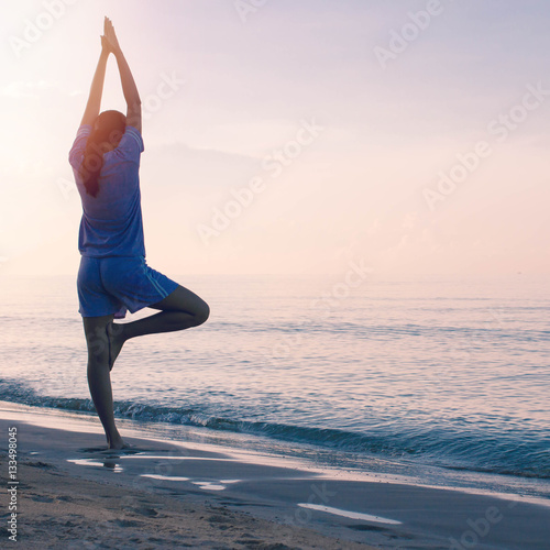 Woman exercise with yoga on the beach background