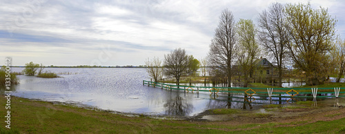 Spring panorama with the river in flood cloudy day