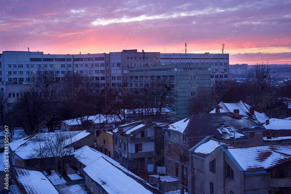 Chisinau emergency hospital in the evening with a purple sunset, roof with snow, winter in moldova