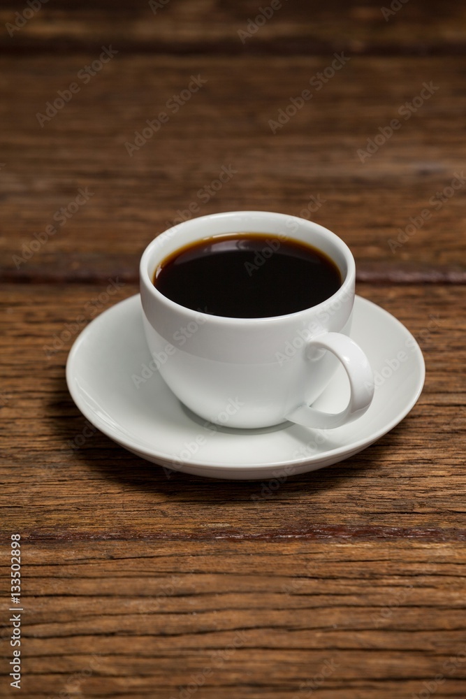 Cup of coffee on wooden table