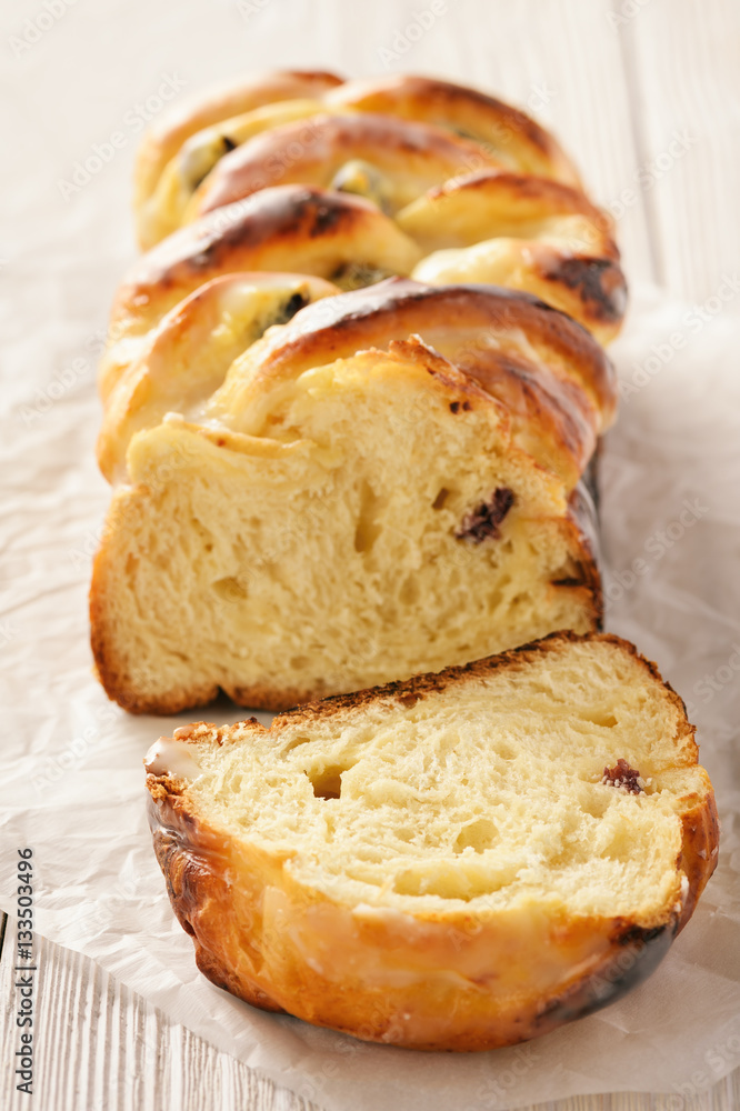 Braided sweet brioche with cheese and dried cranberries.