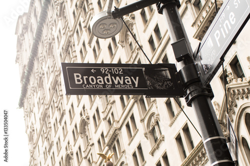 Broadway Street sign with financial district buildings behind it