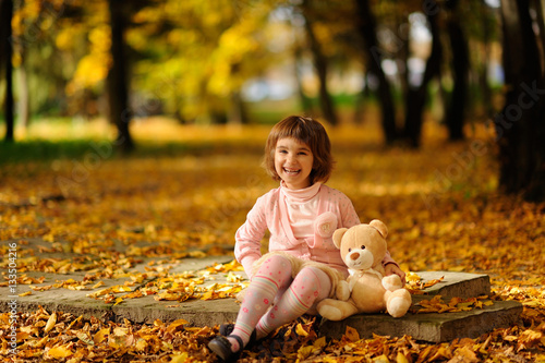 happy little child  laughing and playing in the autumn
