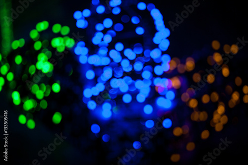 Colorful green, blue, red bokeh on the black background abstract