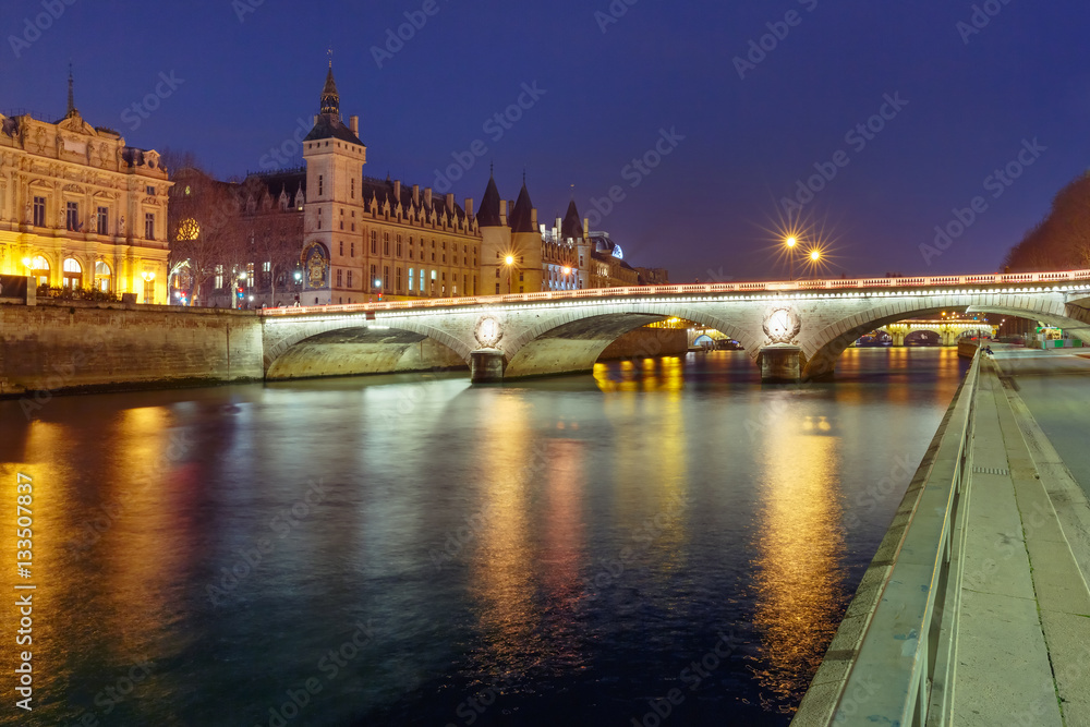 Conciergerie and Illuminated bridge Pont au Change at night, Paris, France
