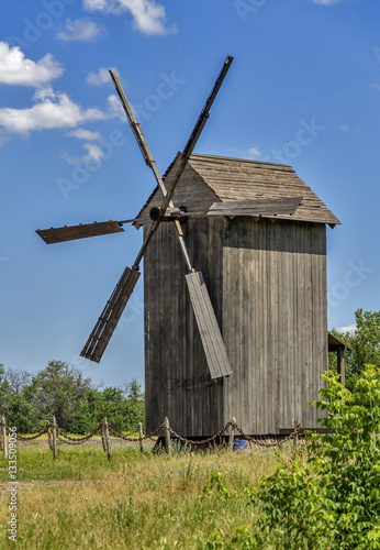 Old wind mill at the park with blue sky clouds