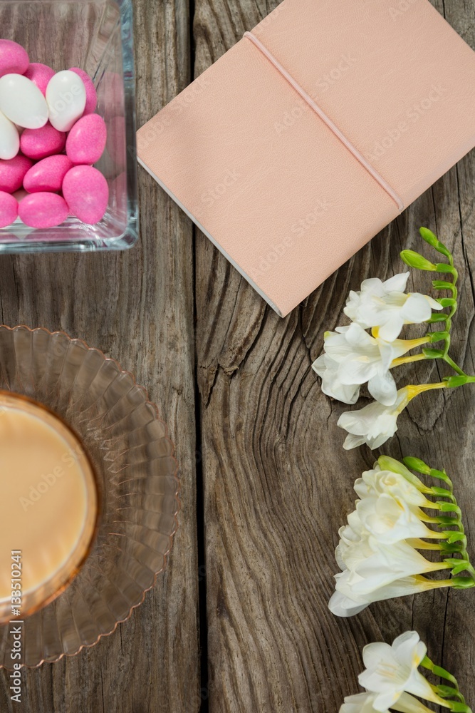 Coffee, book, flowers and easter eggs on wooden table 