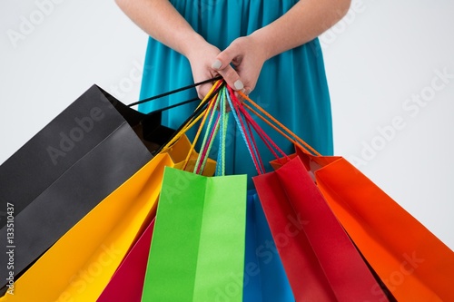 Woman carrying colorful shopping bags