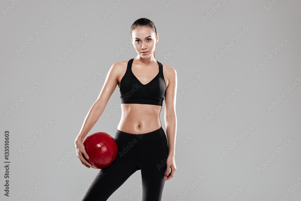 Sporting woman holding ball Sporting woman holding ball
