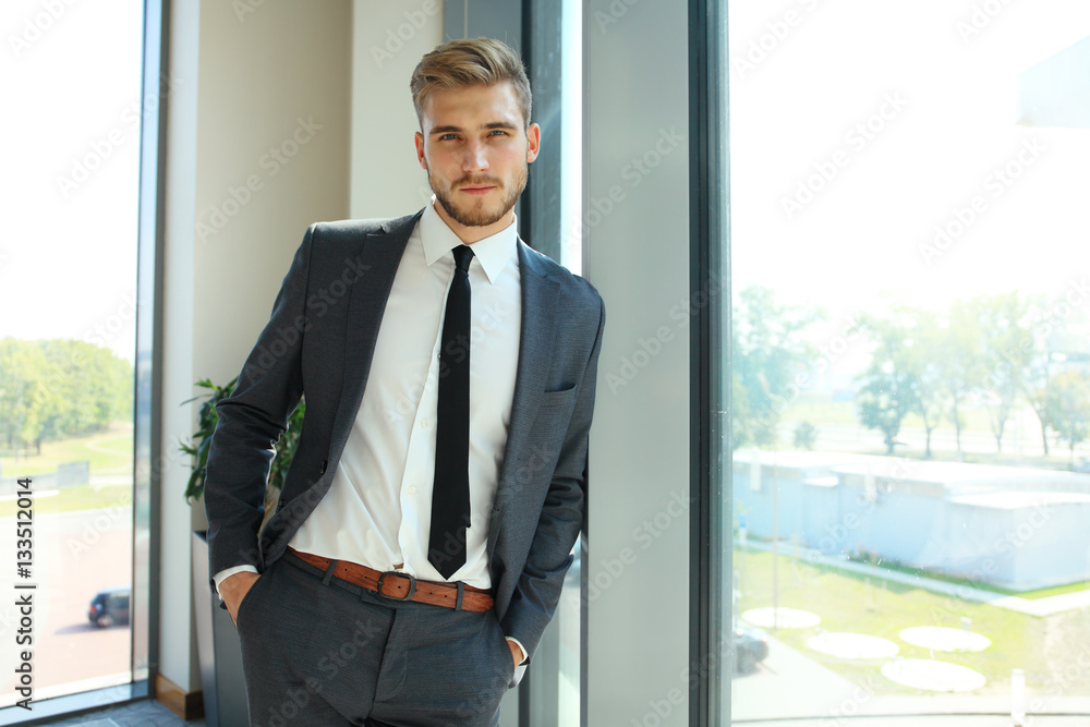 Portrait of a businessman looking at the window. Portrait of a businessman looking at the window.