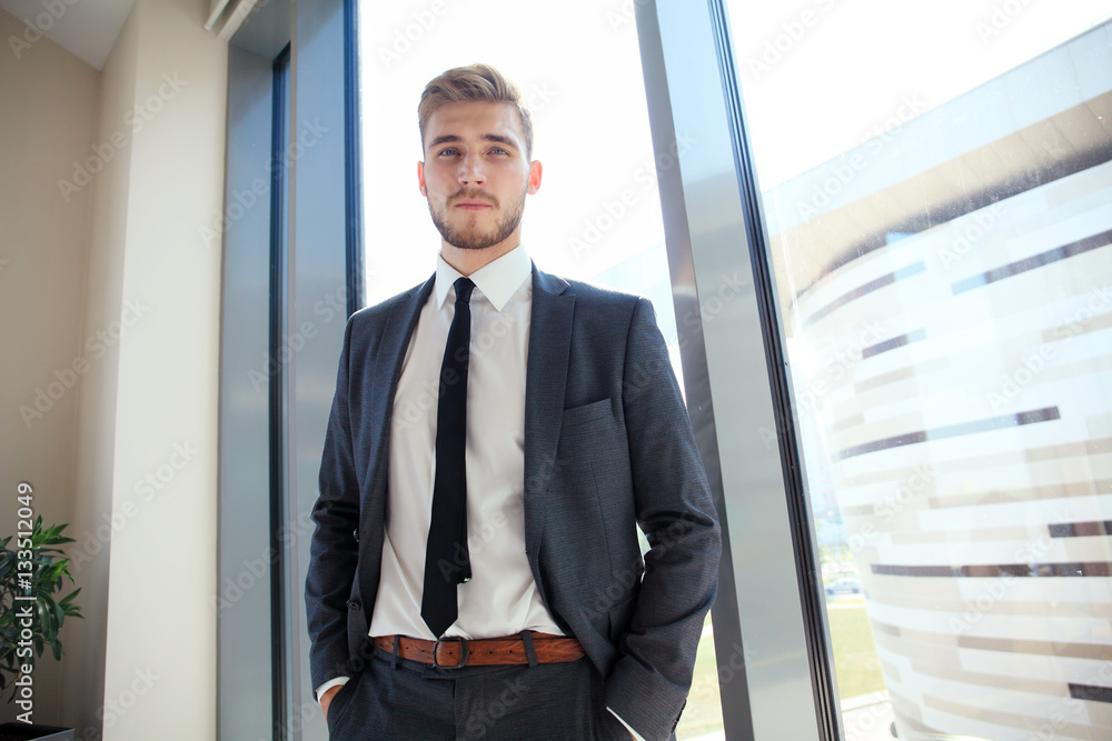 Portrait of a businessman looking at the window. Portrait of a businessman looking at the window.