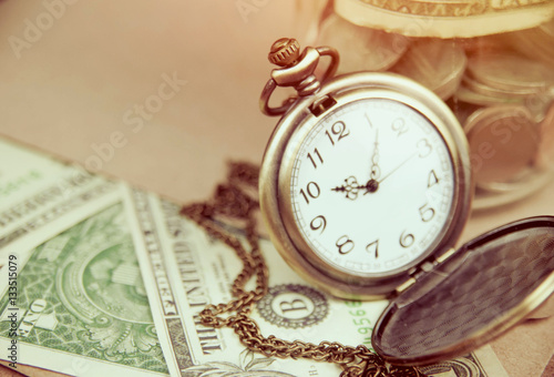 Money saving concept with vintage clock for the past. 