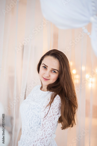 A young girl in a white dress posing on a white background Free Download A young girl in a white dress posing on a white background - GFXLoad