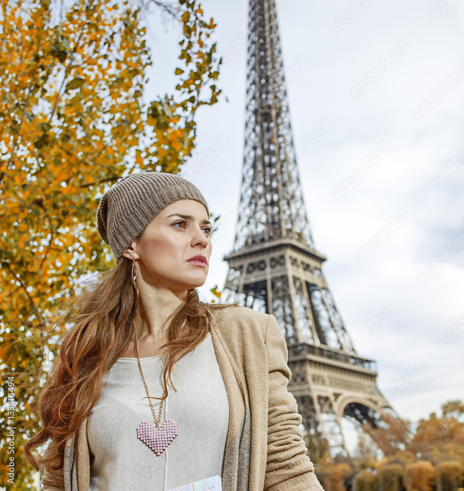 woman  looking into distance on embankment in Paris