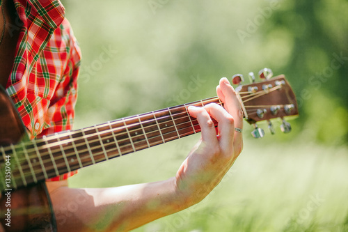 man playing guitar on picnic